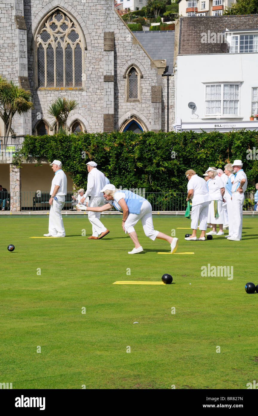 A woman bowling during a crown green bowls game Stock Photo