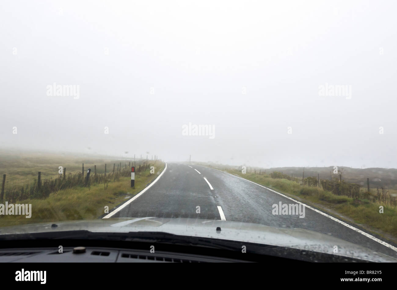 Driving in fog and rain across the top of the Pennines near Holmfirth, West Yorkshire, England, UK Stock Photo
