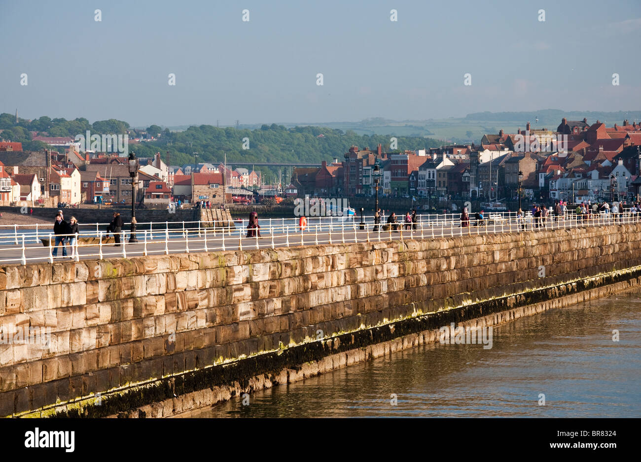 The Harbour wall at Whitby on the Yorkshire Coastline, a popular and bustling fishing town that also attracts many visitors. Stock Photo