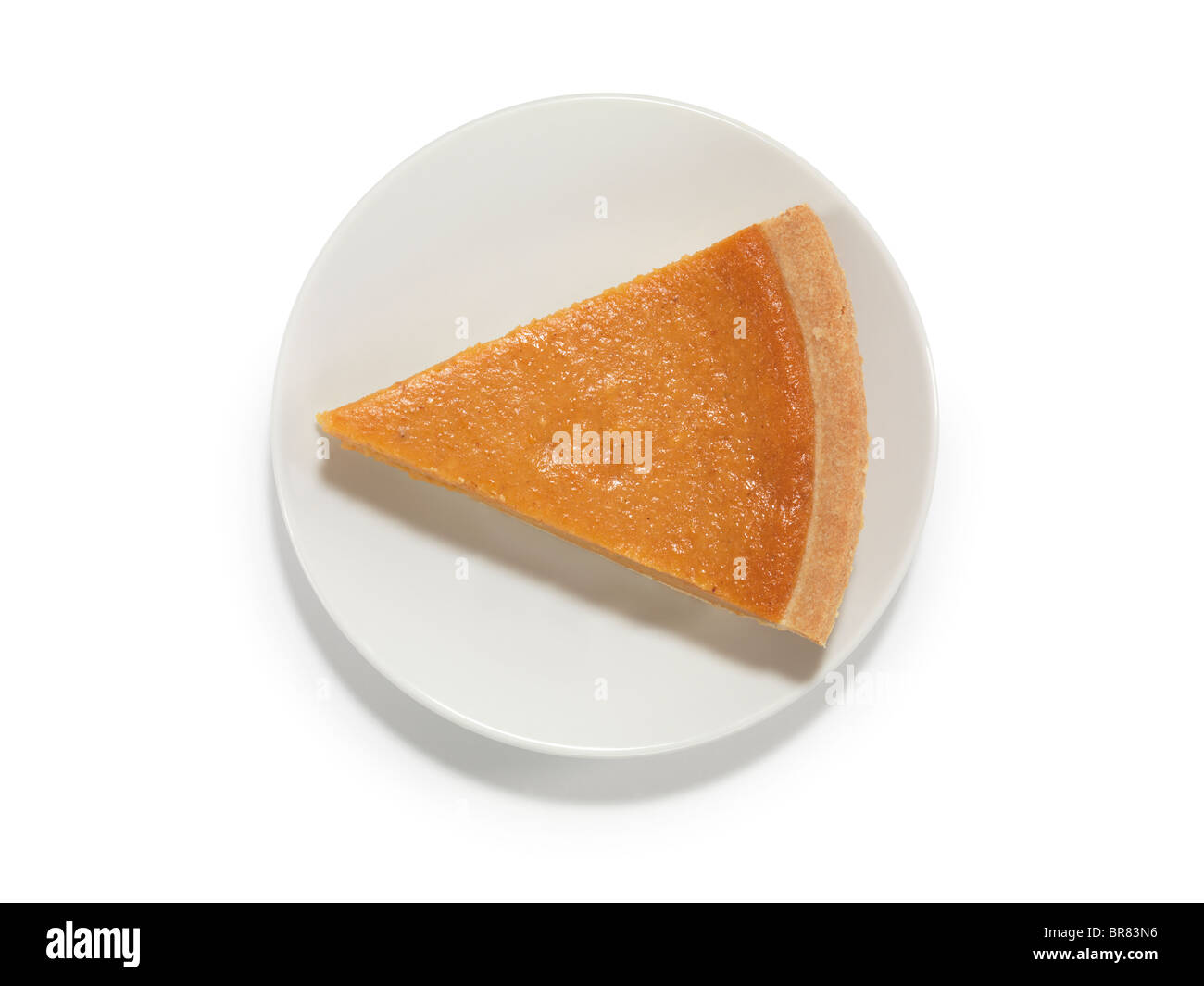 Piece of a pumpkin pie on a saucer isolated on white background with a clipping path Stock Photo