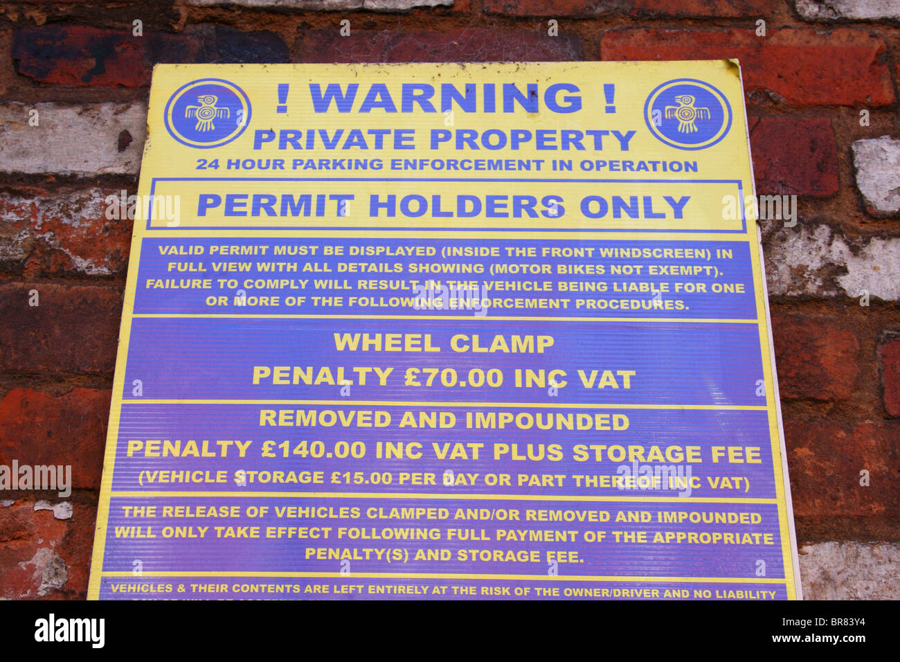 A wheel clamping warning sign in a private car park in a U.K. city. Stock Photo