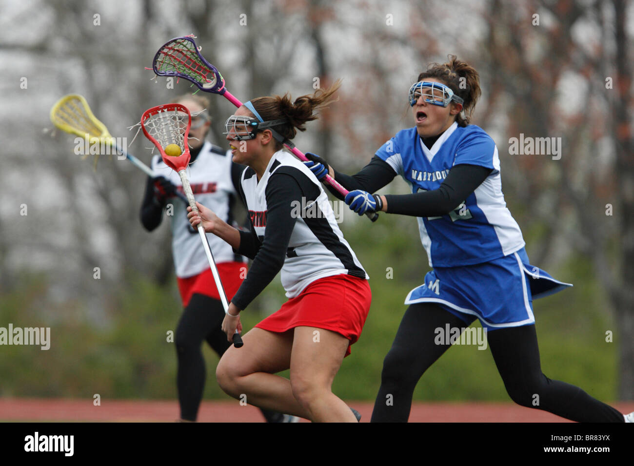 A Marymount University player defends against a Catholic University opponent during a college lacrosse game April 11, 2007. Stock Photo