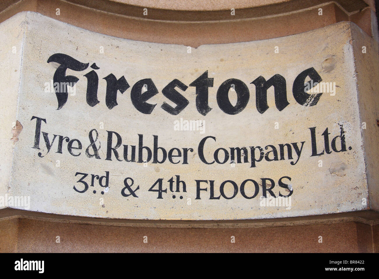 A Firestone Tyre & Rubber Company sign on a building in a U.K. city. Stock Photo