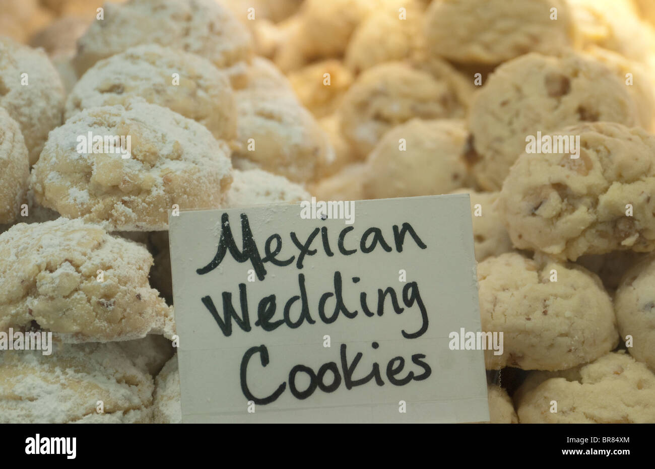 traditional mexican wedding cookies on display at a bakery on linden