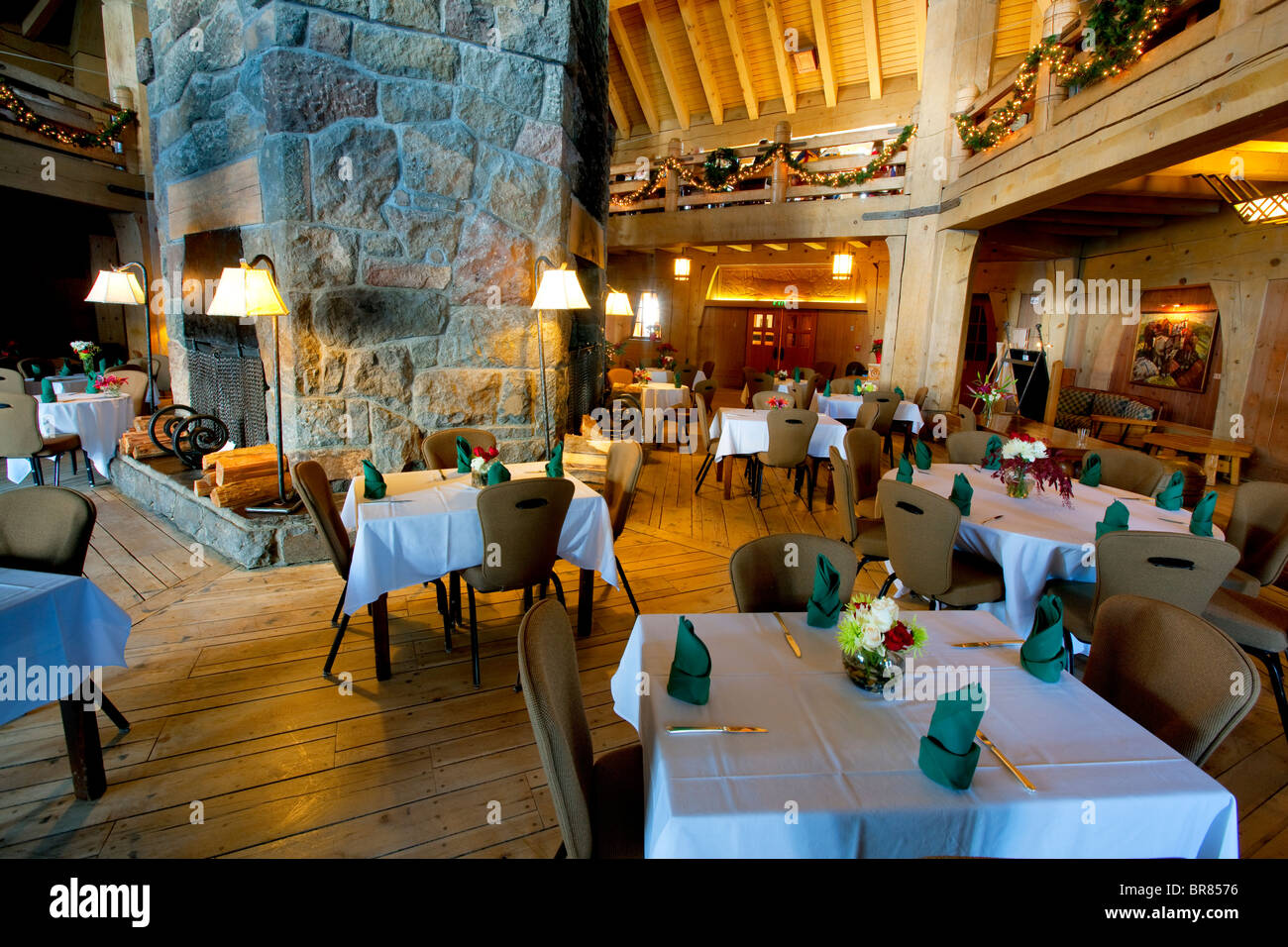 Dining area set for Christmas dinner and stone fireplace at Timberline