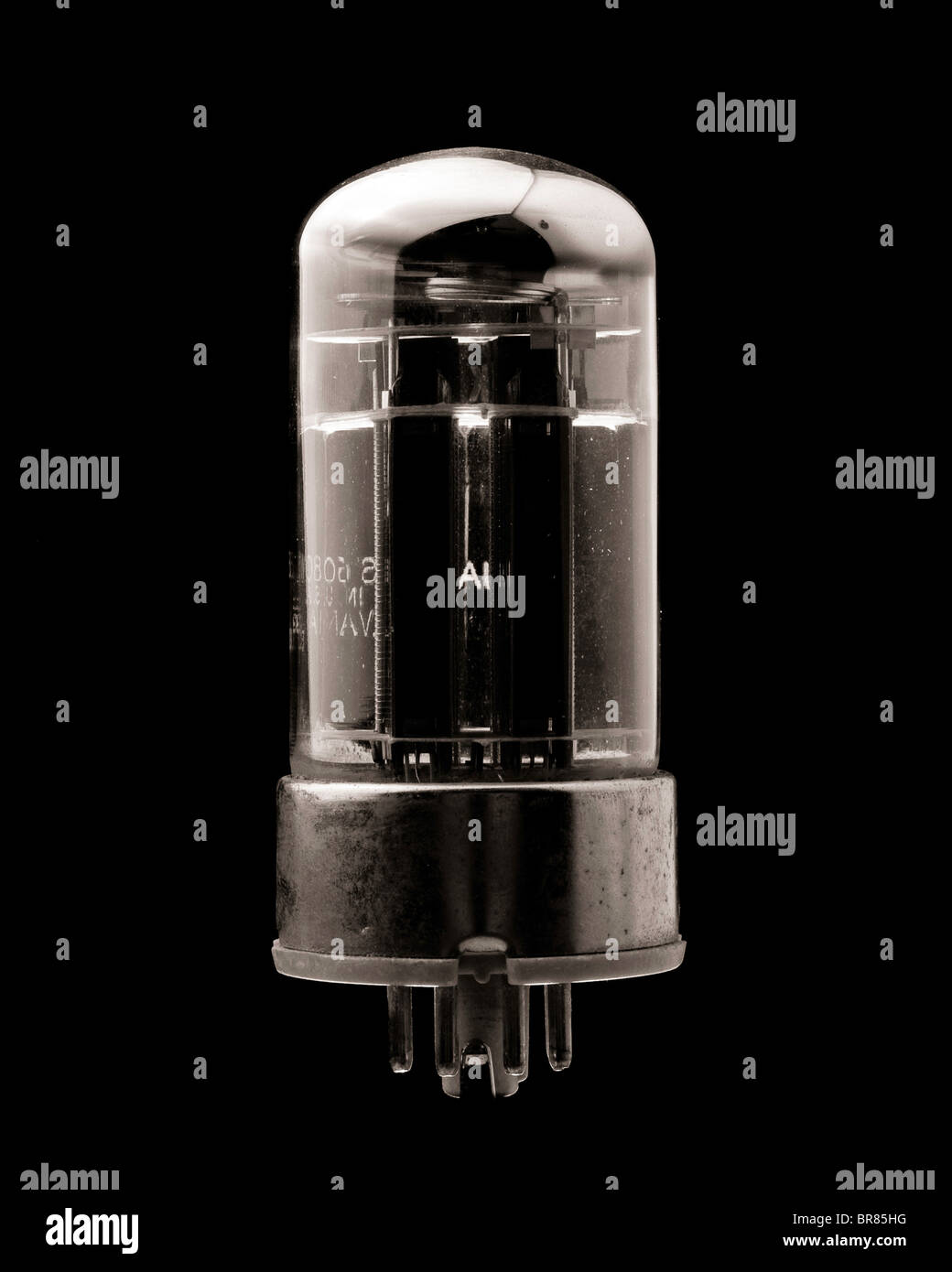 Image of a vintage vacuum tube against a black background.  Possibly a double diode triode - could have seen use as a radio tube Stock Photo