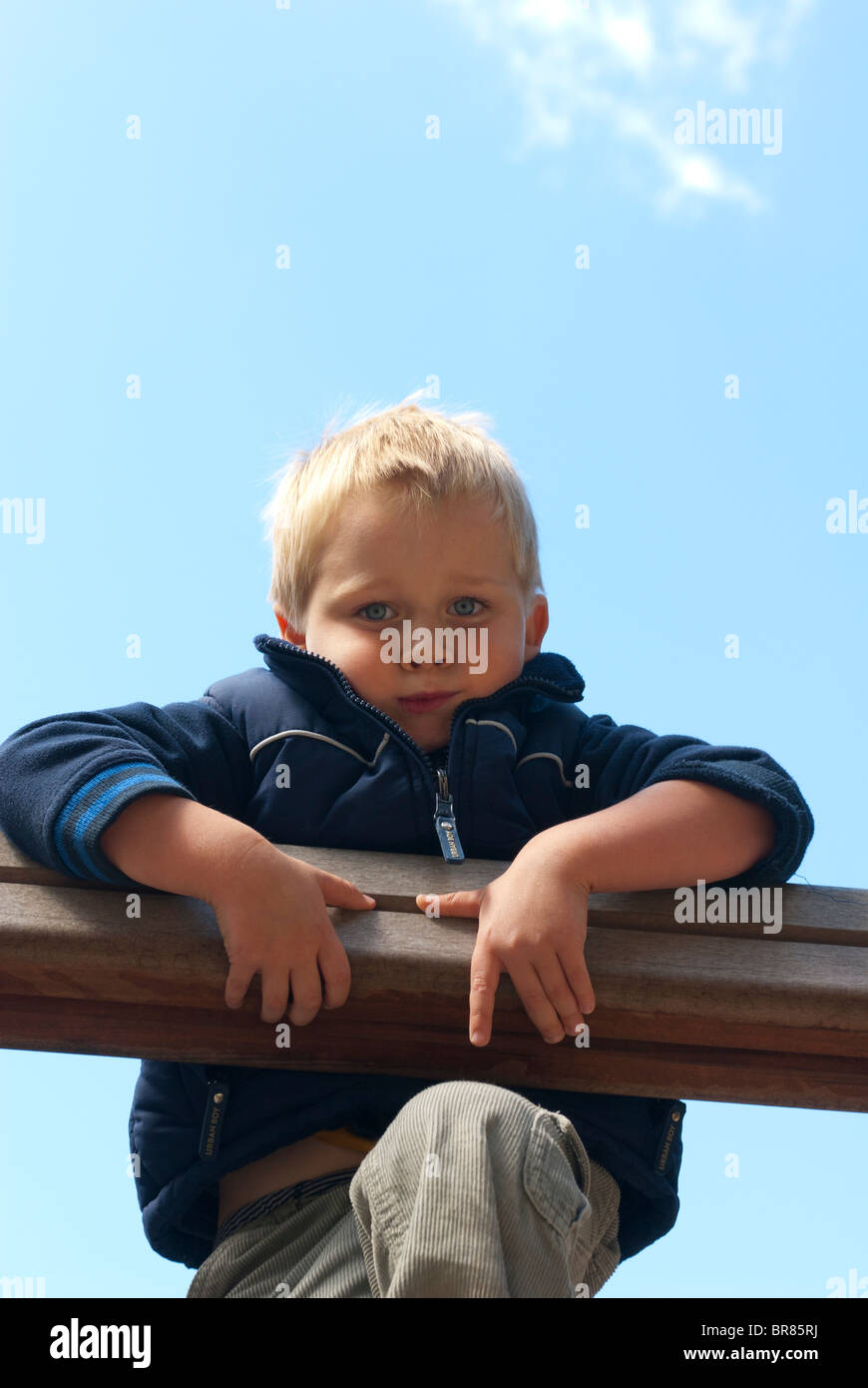 A young blond boy 4 years on a summer playground Stock Photo