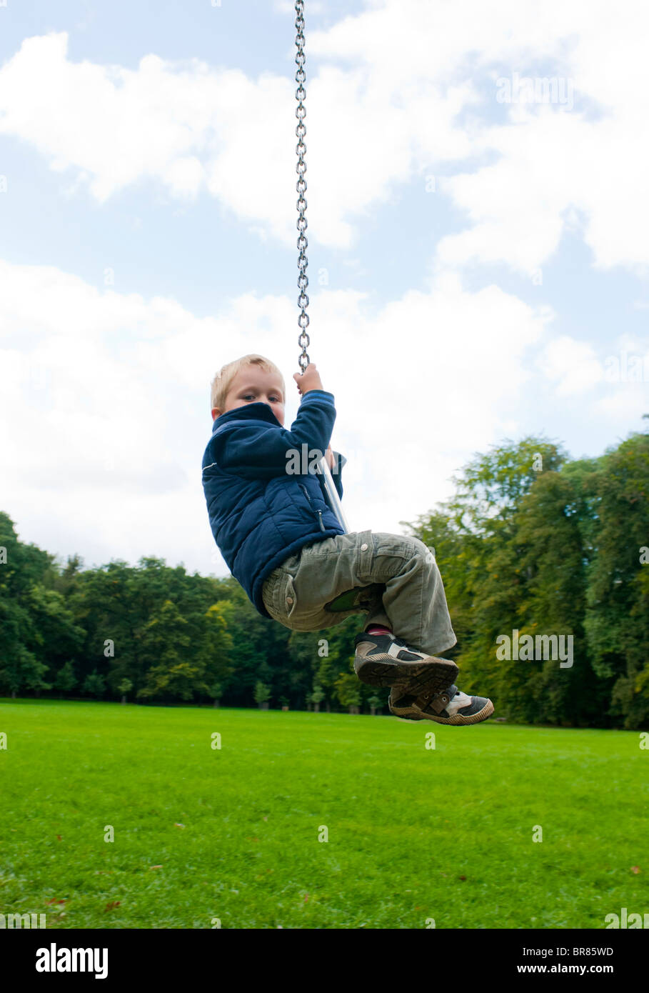 A young blond boy 4 years on a summer playground Stock Photo