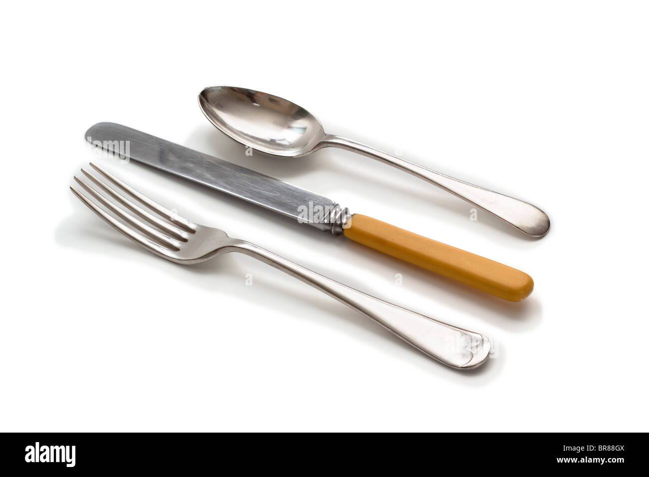 Knife, fork, and spoon.  Old fashioned silver plate with ivory handled knife, Stock Photo