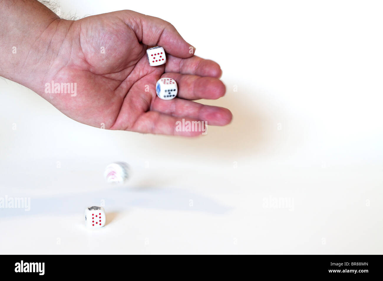 Hand rolling dice. Roll of the dice Stock Photo