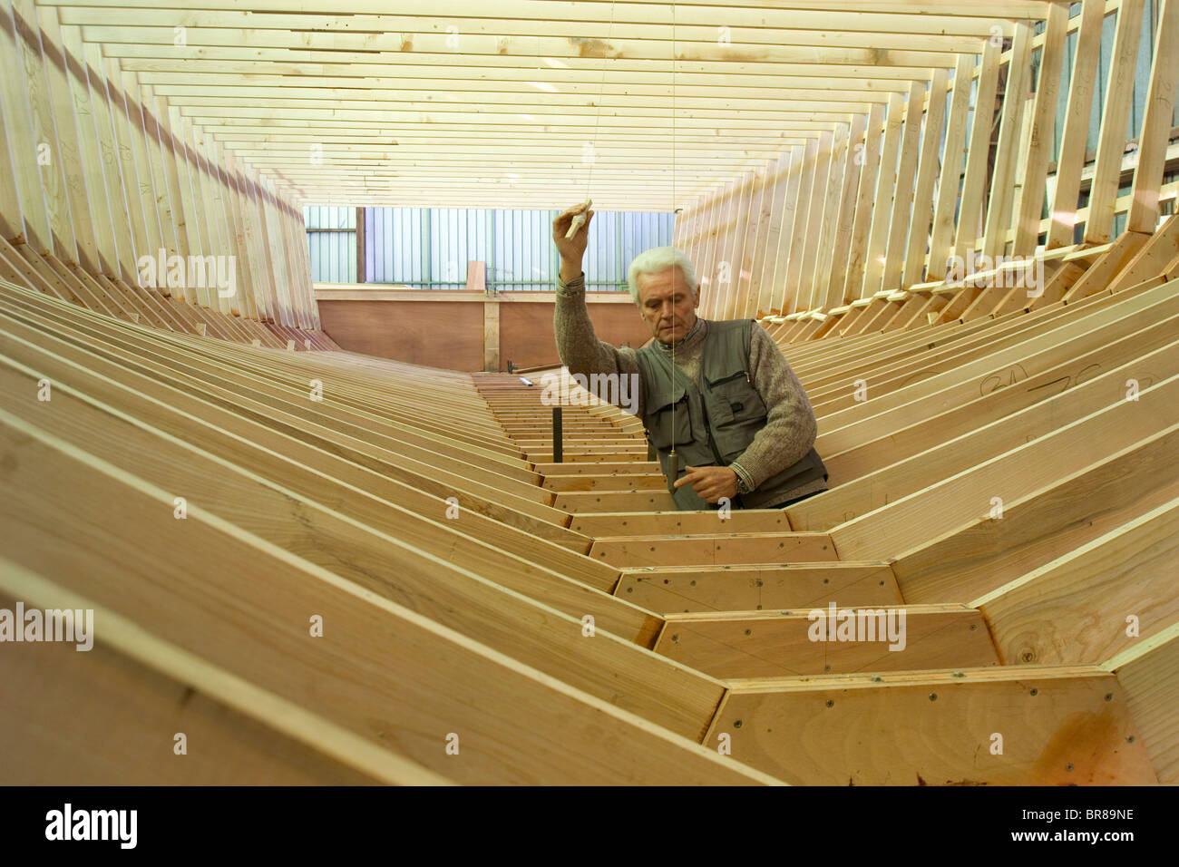 Shipwright at work with a plumb line during construction of a 38metre