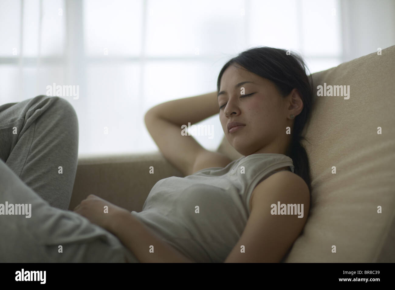 Young Woman Taking Nap on Sofa Stock Photo Alamy