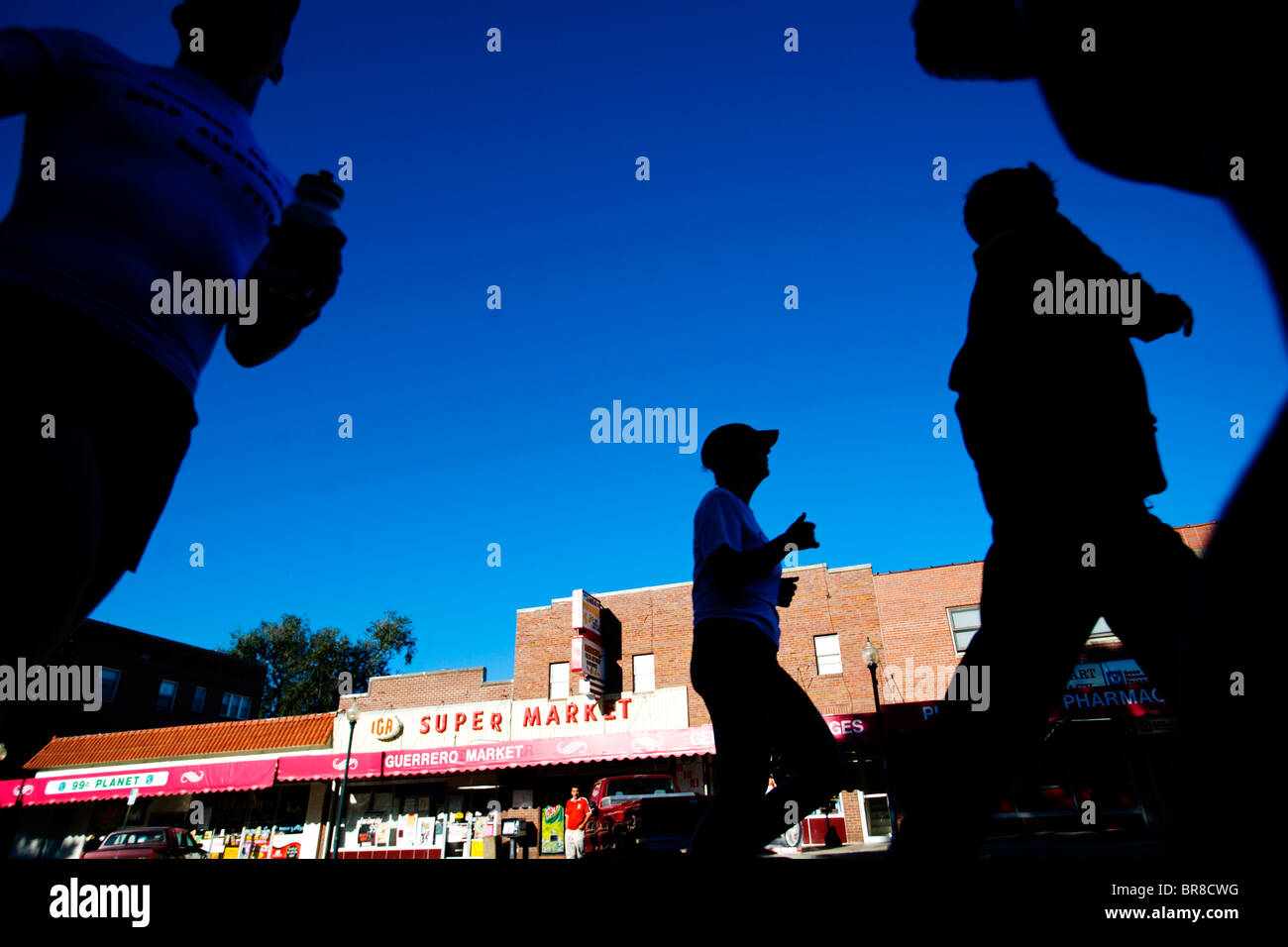 People running a marathon in Lincoln Nebraska (Silhouette Stock Photo