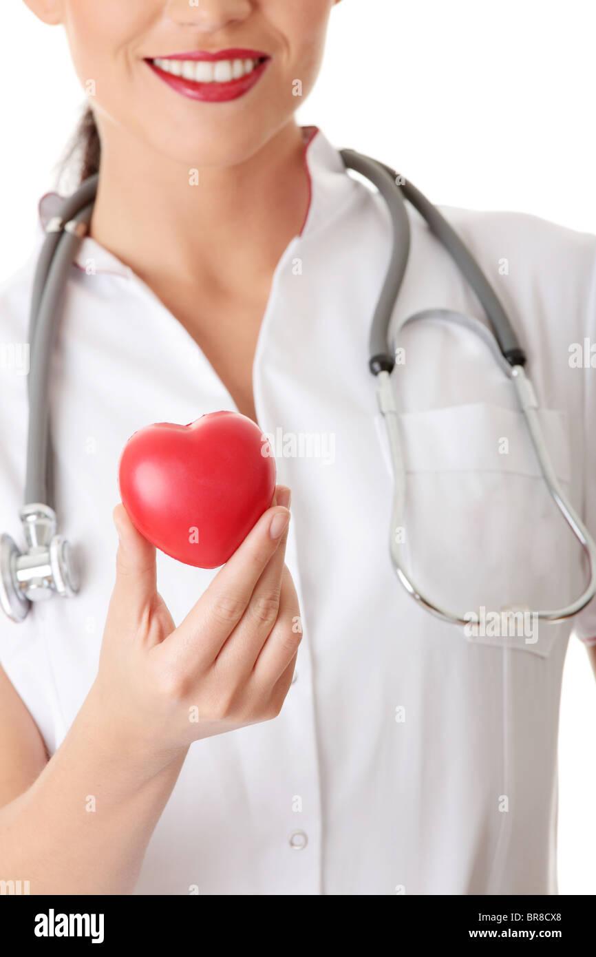 Young doctor with heart in her hand, isolated on white background Stock ...