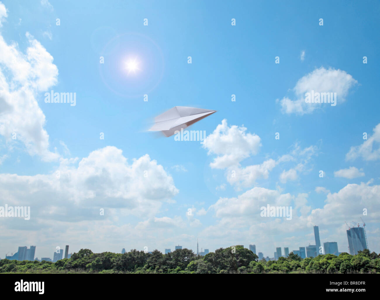 Paper airplane flying and Tokyo skyline Stock Photo