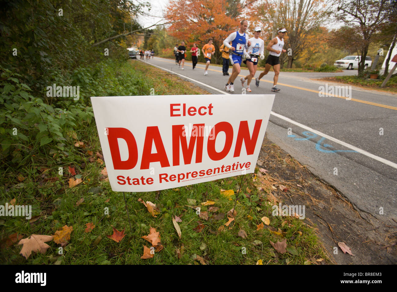 Runners passing an election sign during a marathon in Portland Maine. Stock Photo