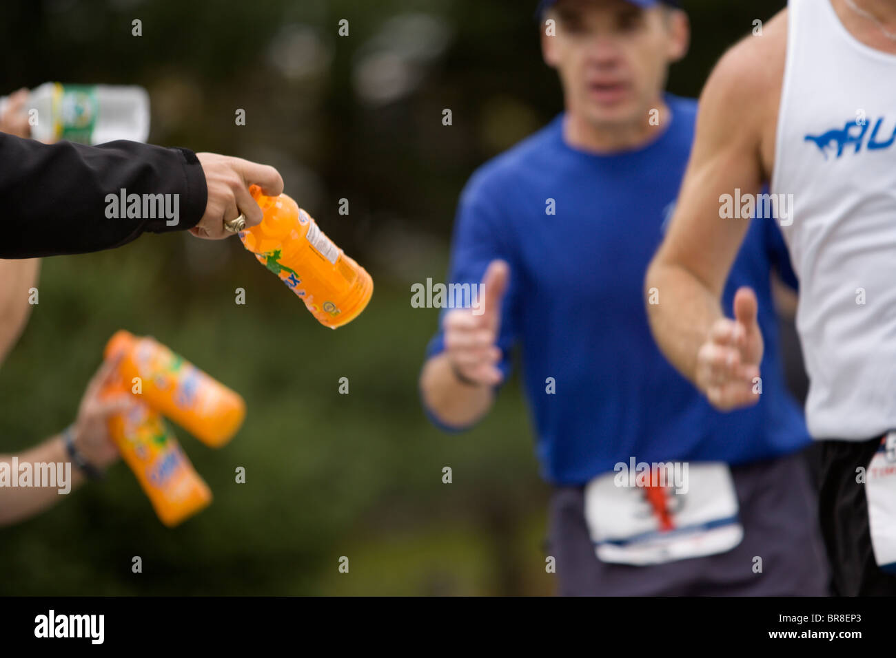 Runners grabbing energy drinks during a marathon in Stowe Vermont Stock