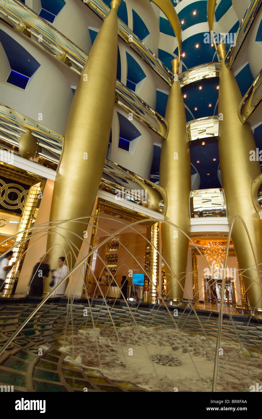 Gold columns rise above a fountain in the lobby of the luxurious Burj al Arab Dubai Stock Photo