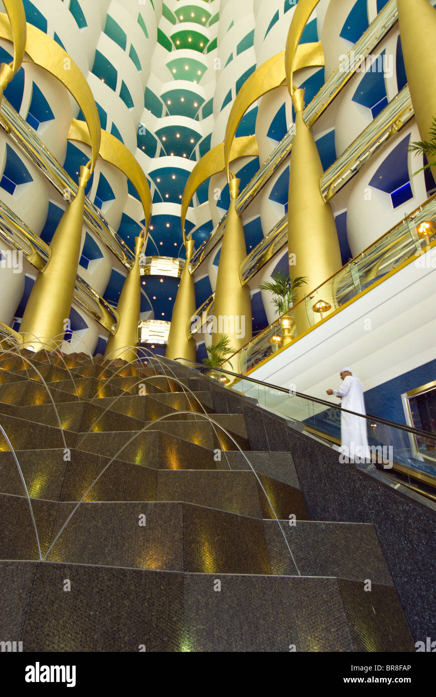 Gold columns rise above a fountain in the lobby of the luxurious Burj al Arab hotel Dubai Stock Photo
