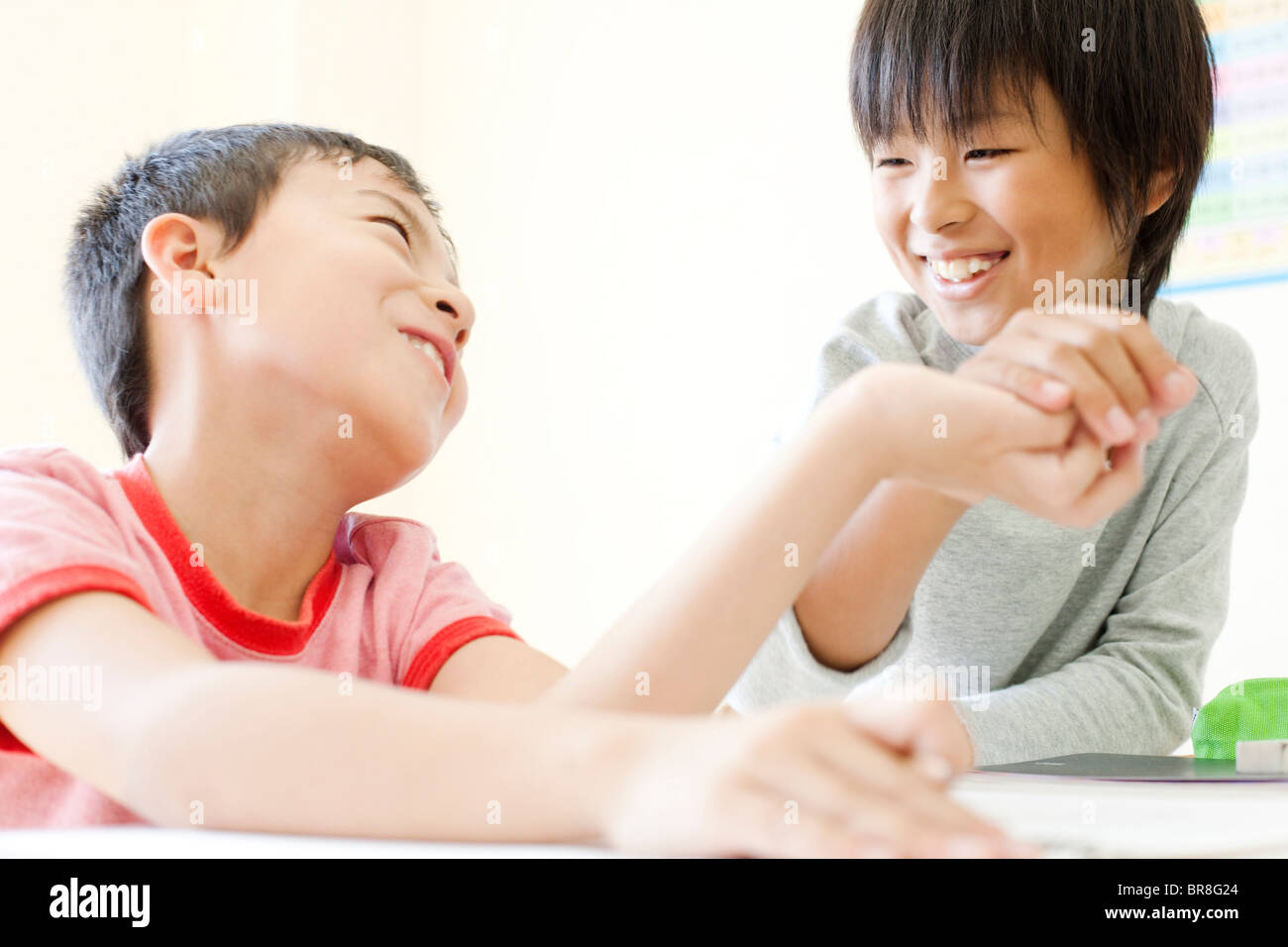Boys arm wrestling during a break Stock Photo Alamy