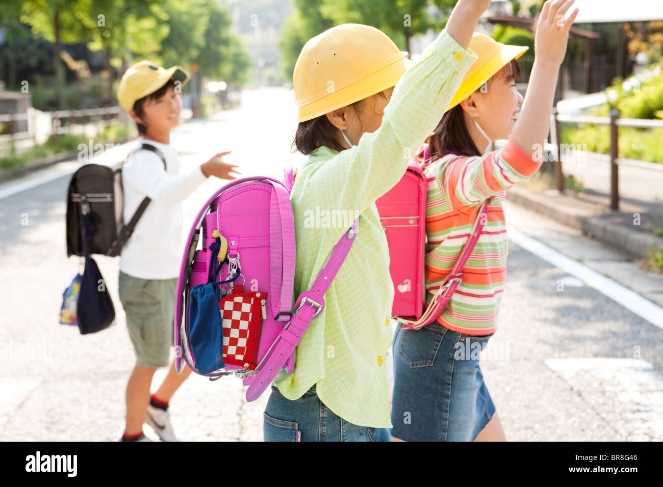 Elementary school students crossing the street Stock Photo - Alamy