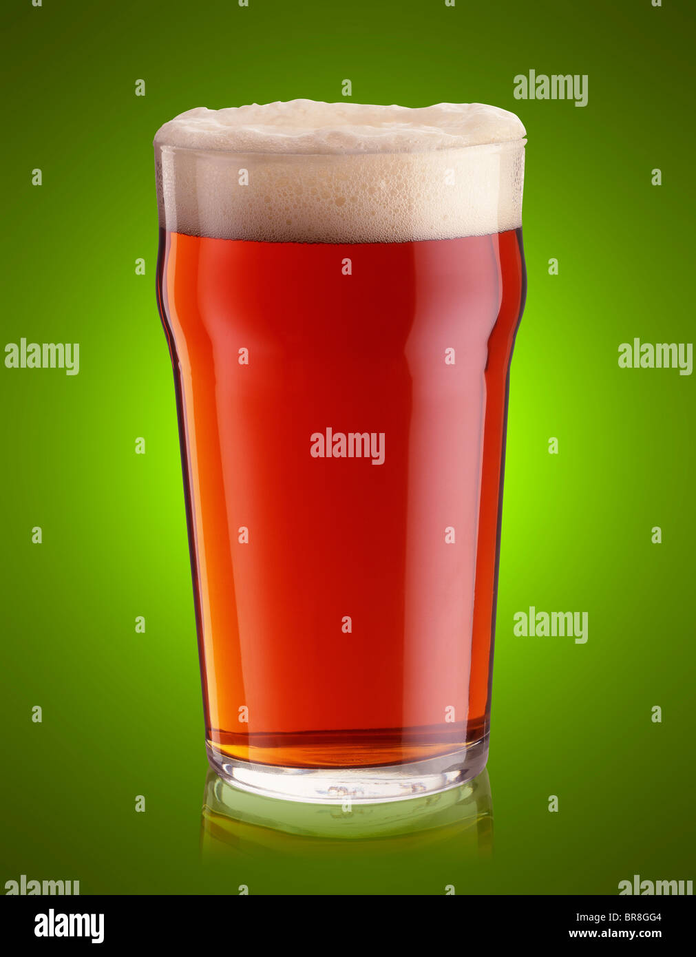 pint of bitter on a green graduated background Stock Photo
