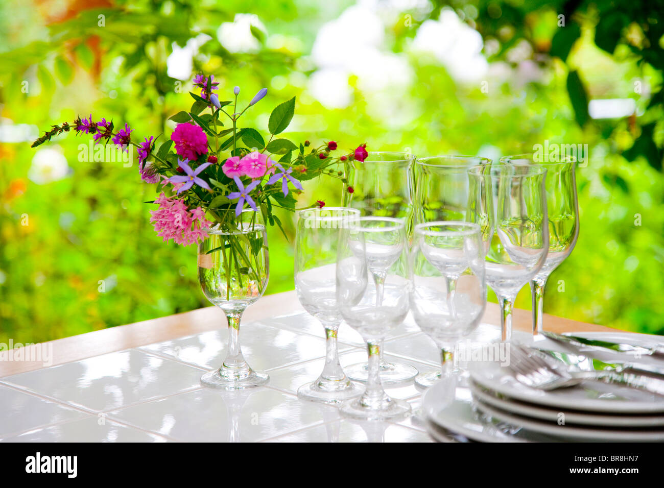 Vase of flowers and tableware on table Stock Photo Alamy