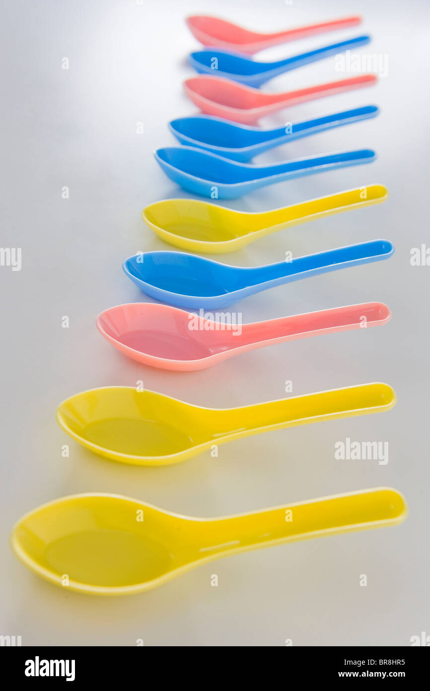 Colorful plastic spoons, white background Stock Photo - Alamy