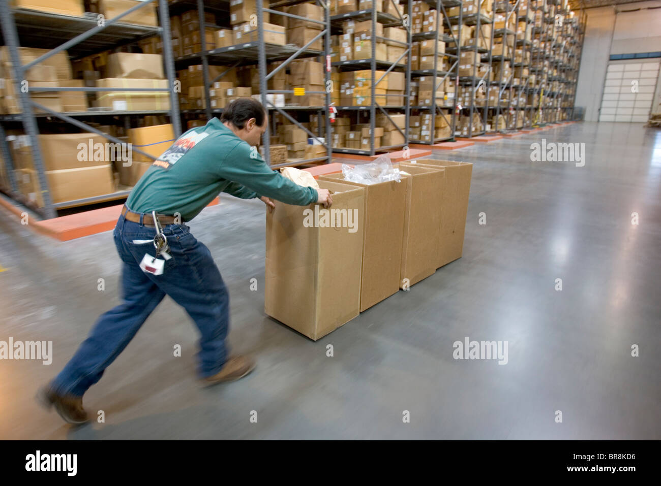 A man moving recycling boxes in a clothing distribution center in Reno