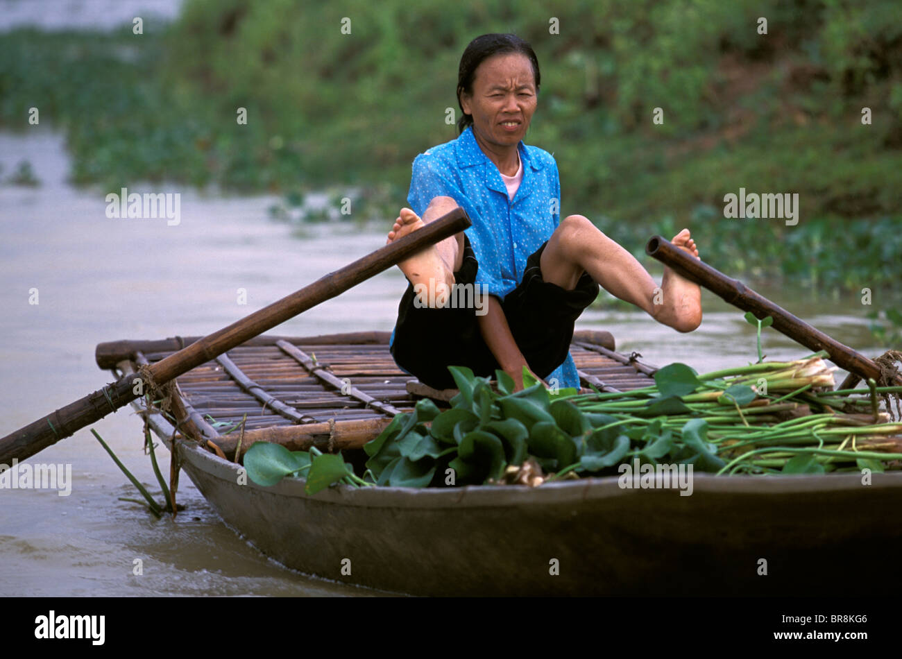 Woman rowing a boat with her feet near Tam Coc Vietnam Stock Photo Alamy