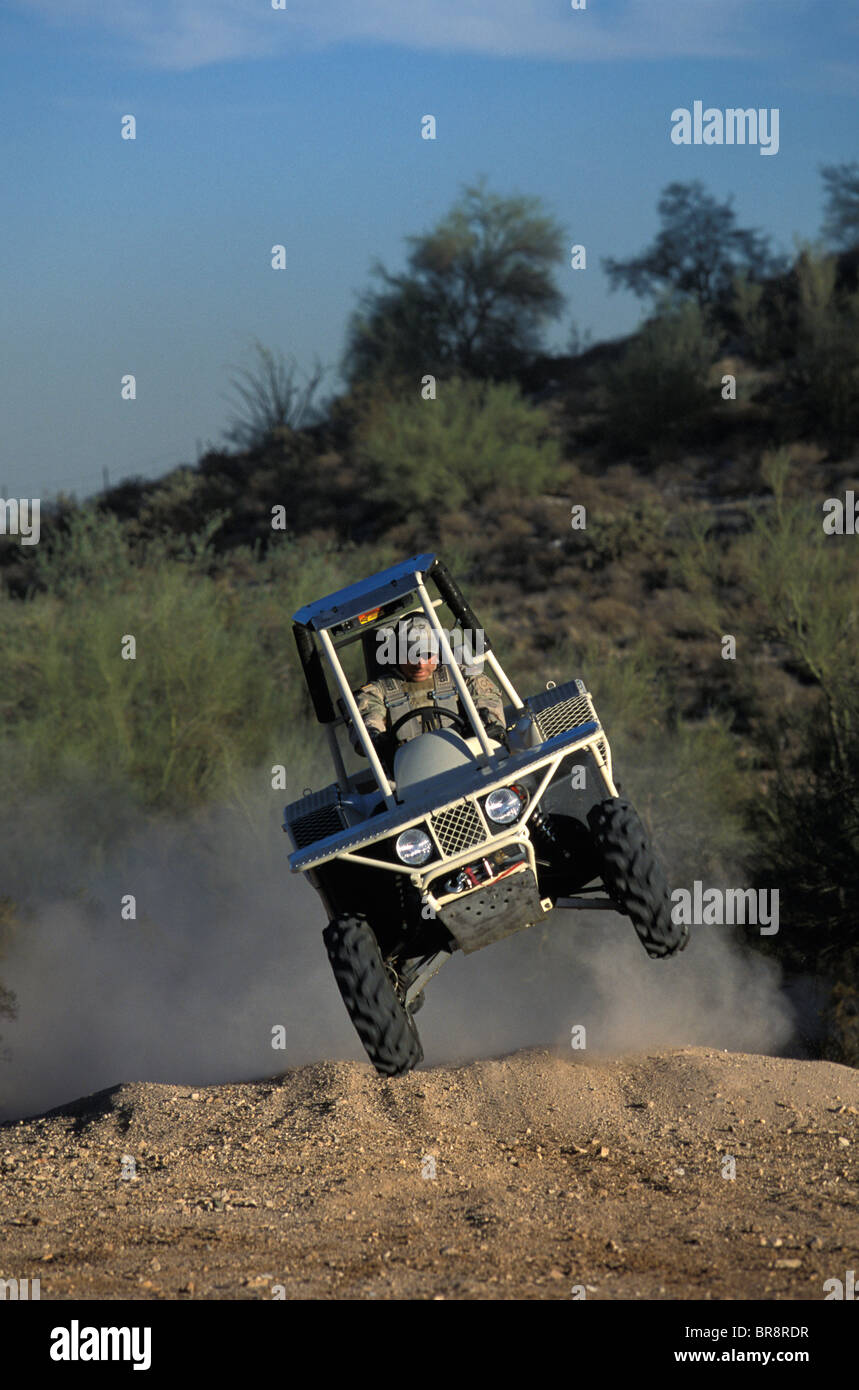 Prowler / All Terrain Vehicle jumping over a mound of dirt near Phoenix Arizona. Stock Photo