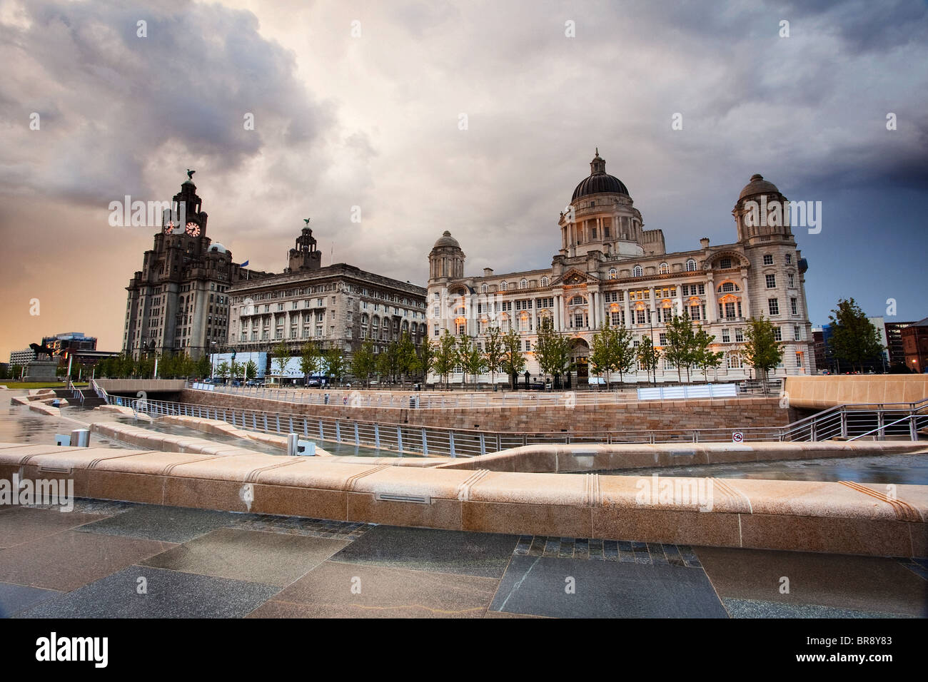 A dramatic stormy evening sky over Liverpool's Three Graces and Canal Link on the Waterfront Stock Photo