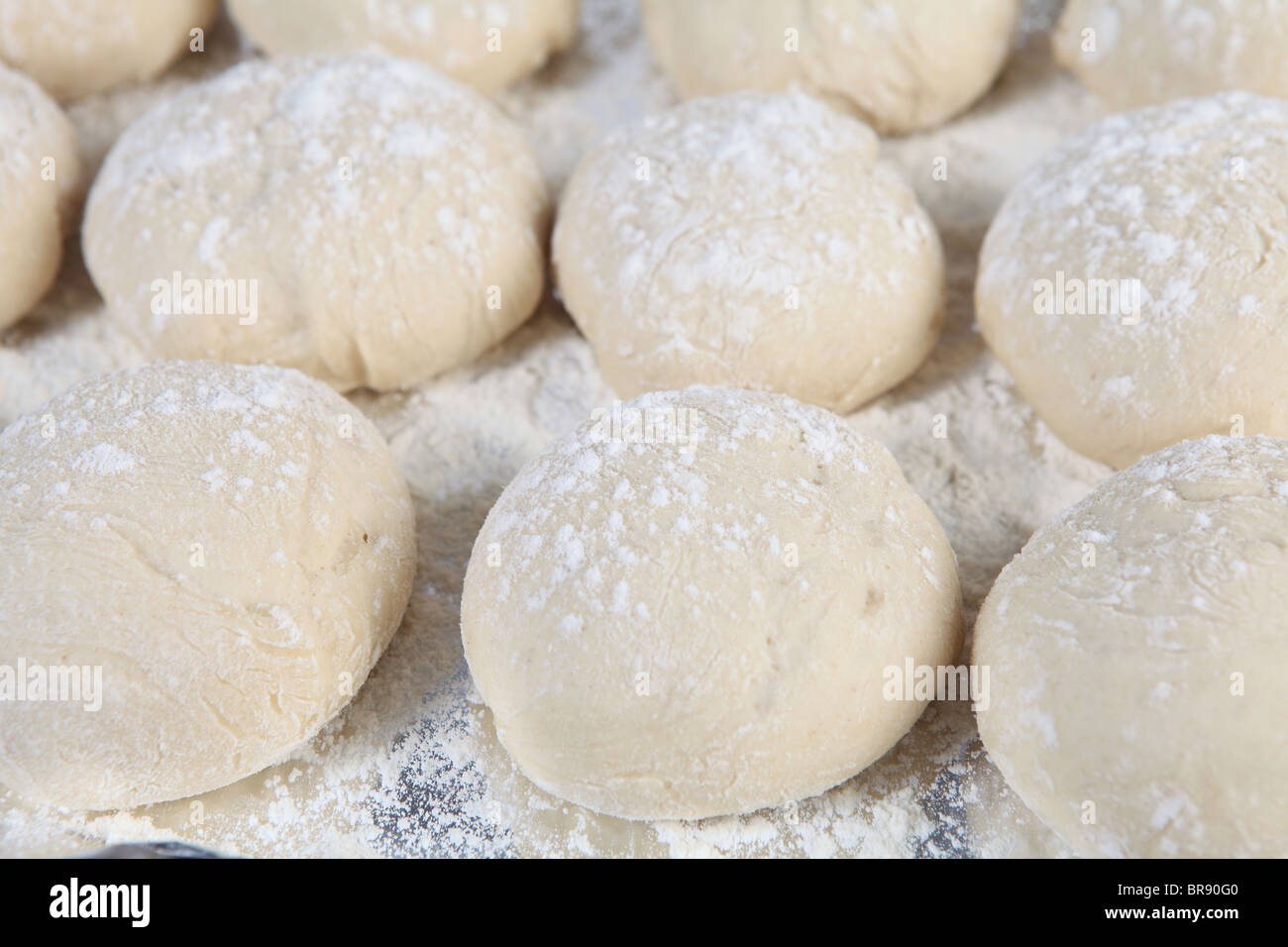 A tray of breakfast rolls rising just prior to baking Stock Photo
