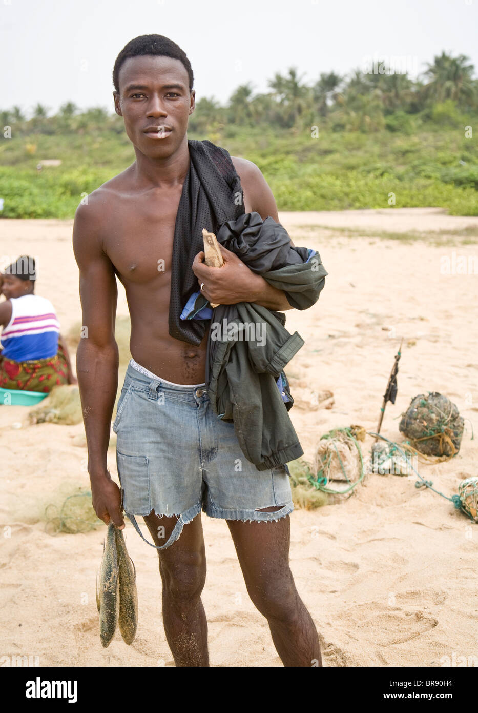 Young fisherman with his catch on a beach in Sierra Leone Stock Photo
