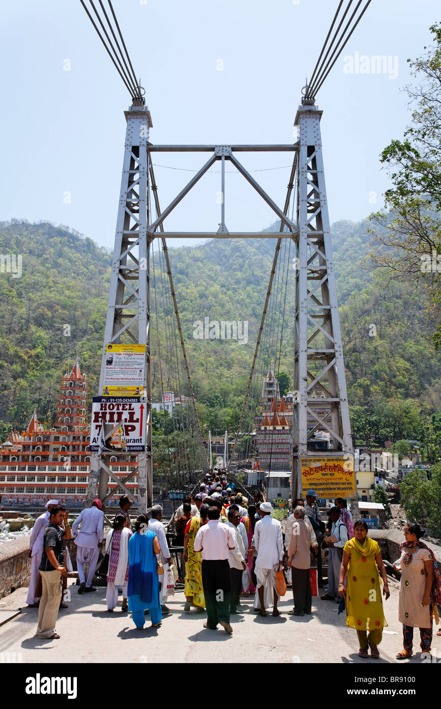 People crossing the Lakshmanjhula Bridge, Rishikesh, Uttaranchal, India Stock Photo