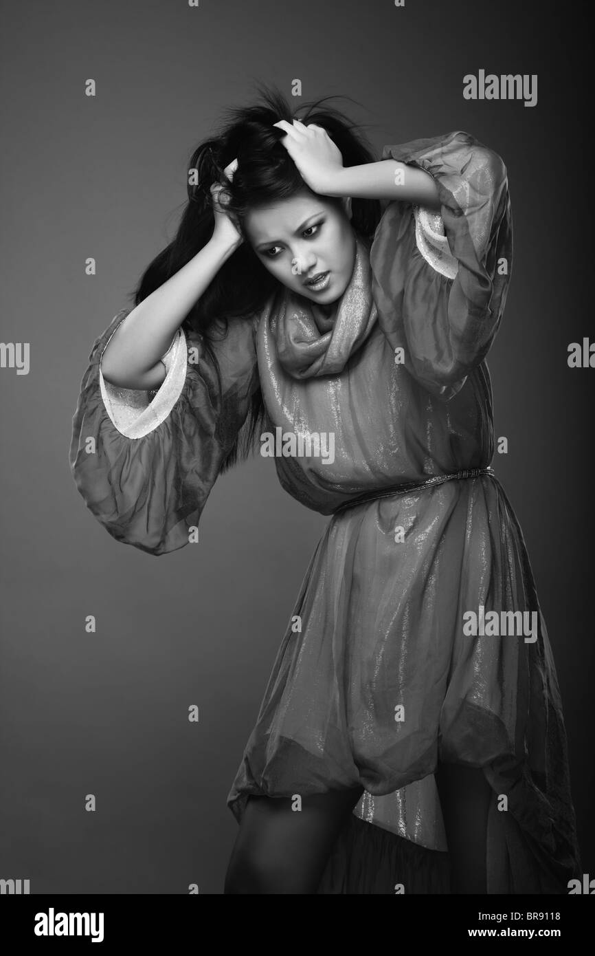 Lady in the studio suffering from the headache and depressive insomnia. Black and white photo Stock Photo