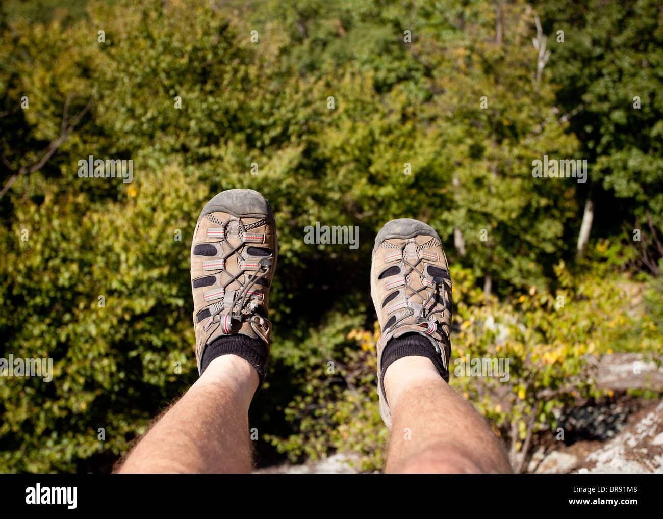 Hiker looks over valley in the Shenandoah on a climb of Old Rag with ...
