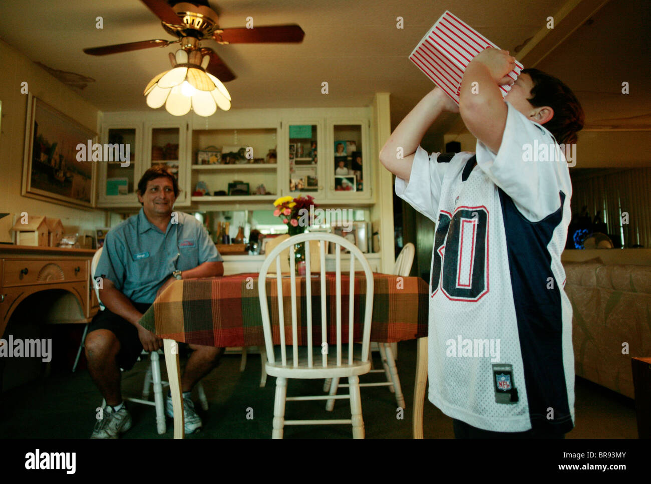 A Boy Eating Popcorn In A Trailer Home In Naples Florida Stock