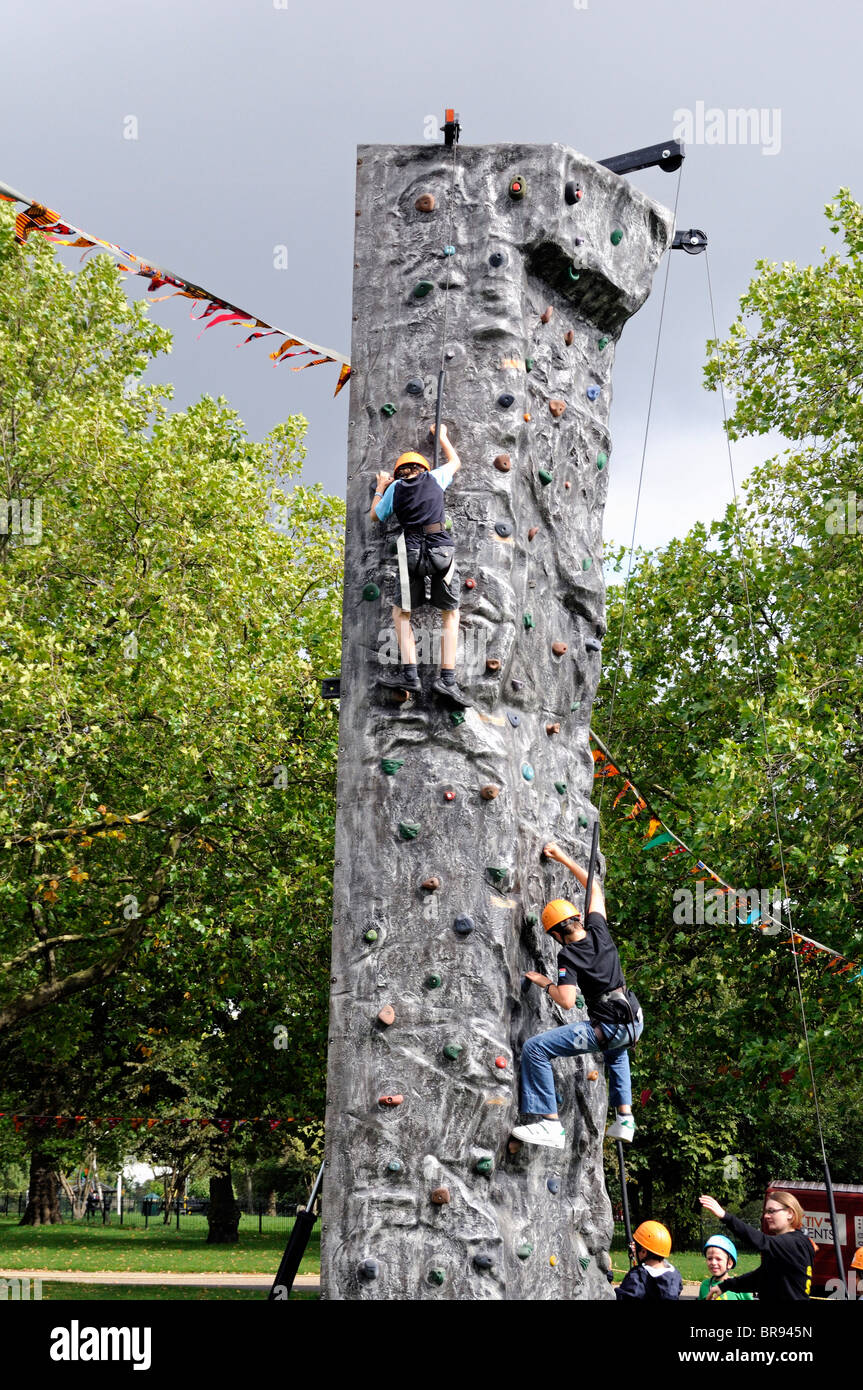 Children on freestanding climbing wall Stock Photo