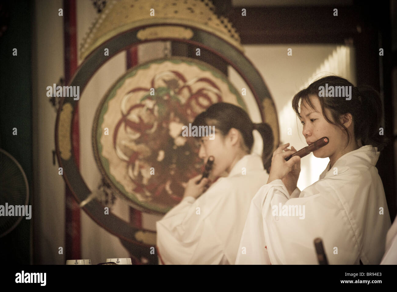 Two Women Playing The Shinobue Flute In The Ikukunitama Shrine A Stock Photo Alamy