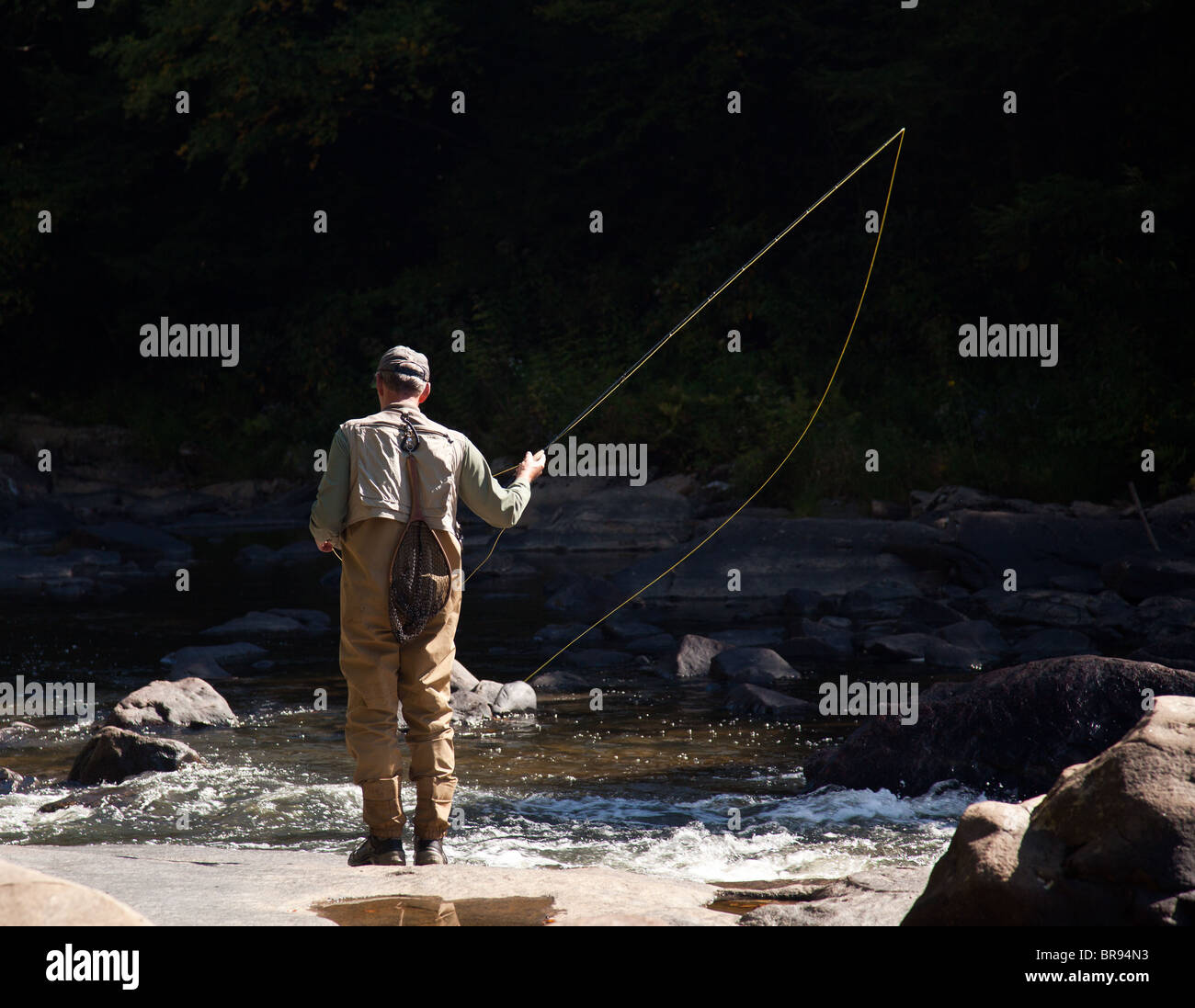 Angler flyfishing in a rapid river near swallow falls in Maryland Stock Photo