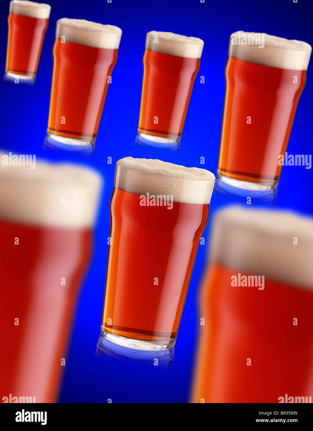 7 pints of bitter real ale on a blue background Stock Photo