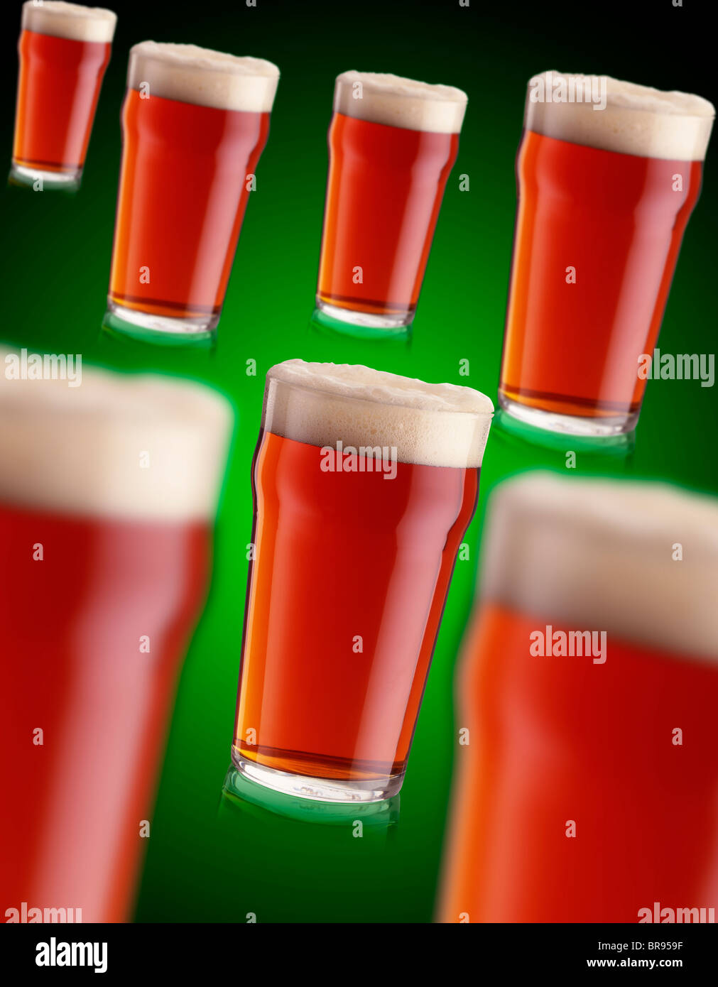 7 pints of bitter real ale on a green background Stock Photo