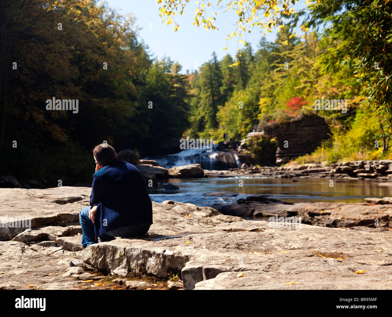 Lady watching the upper falls in Swallow Falls State Park in Maryland