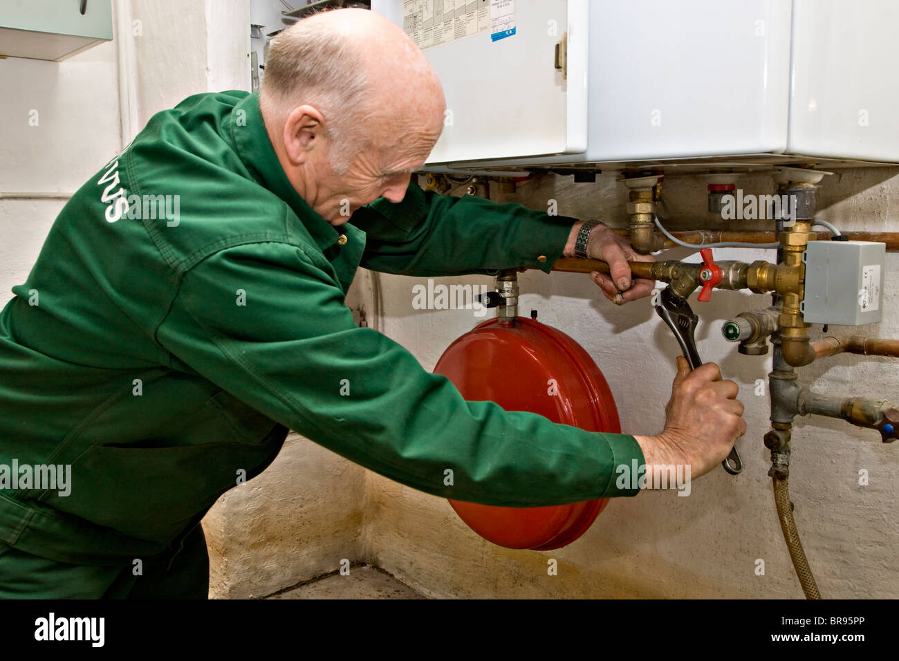 Heating and sanitary technician testing and adjusting a gas heater