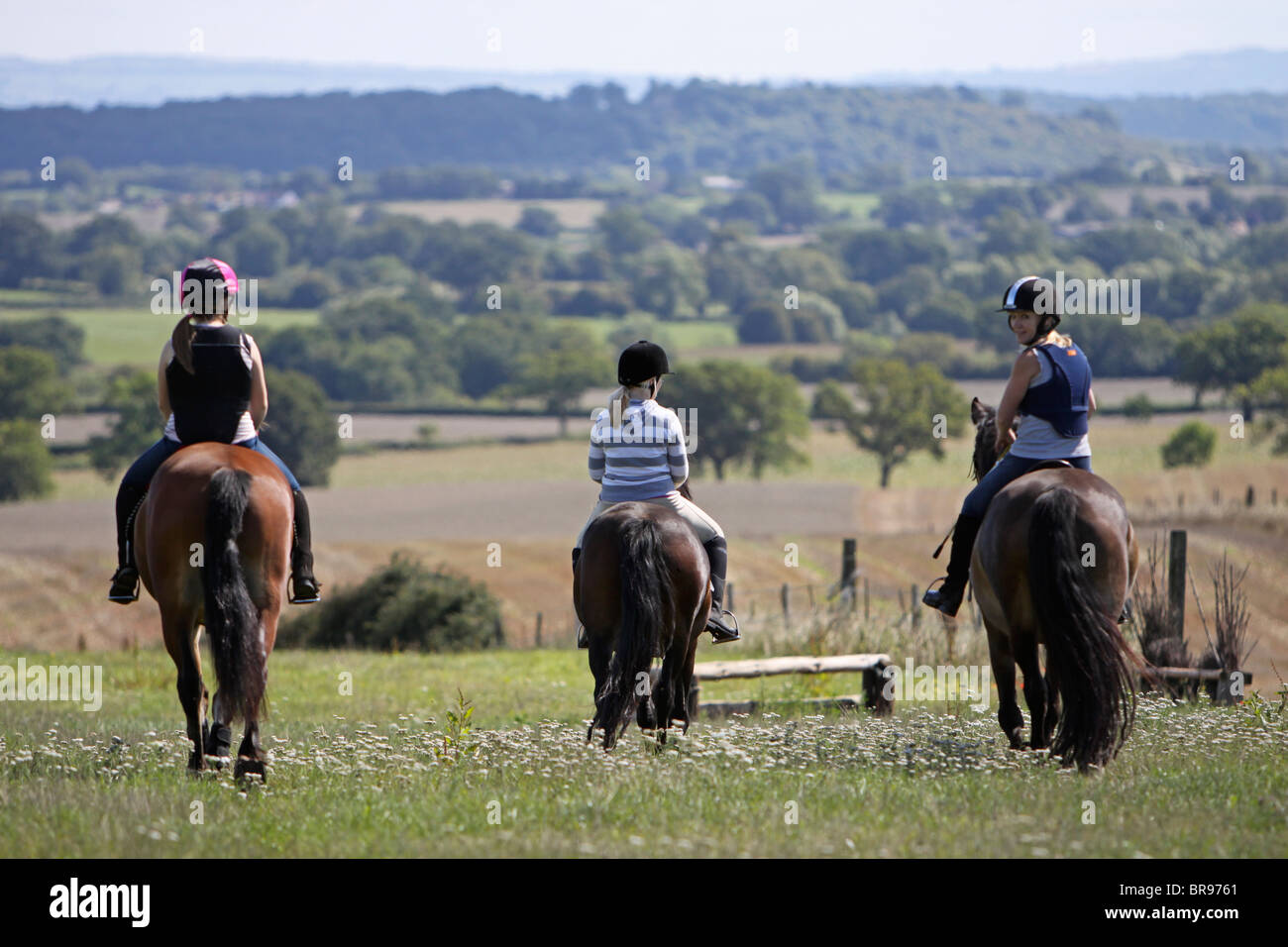 Foot Riding Away Three riders walking their horses away from the camera Stock Photo - Alamy