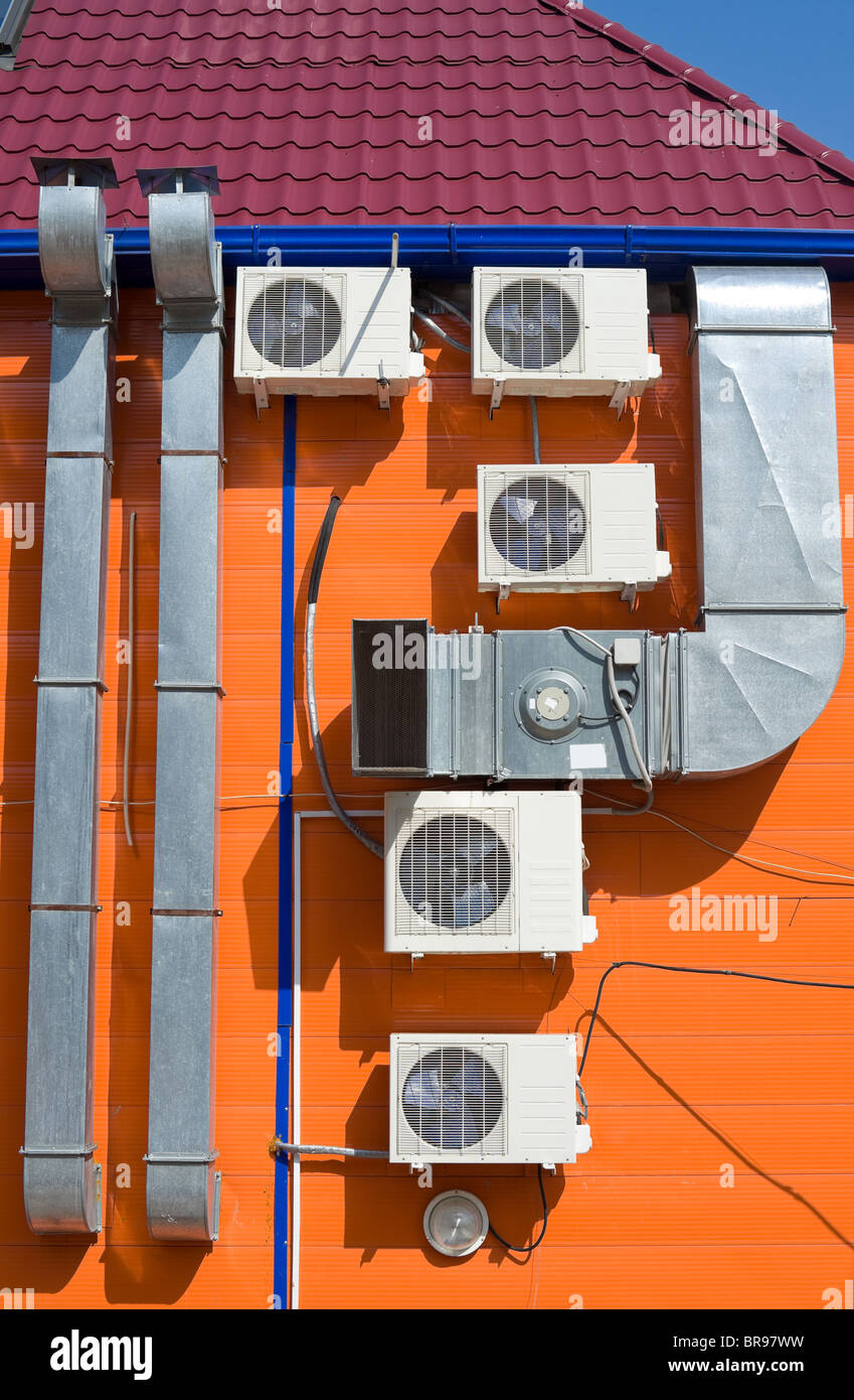 ventilation tubes and some air conditioners on an outer wall Stock