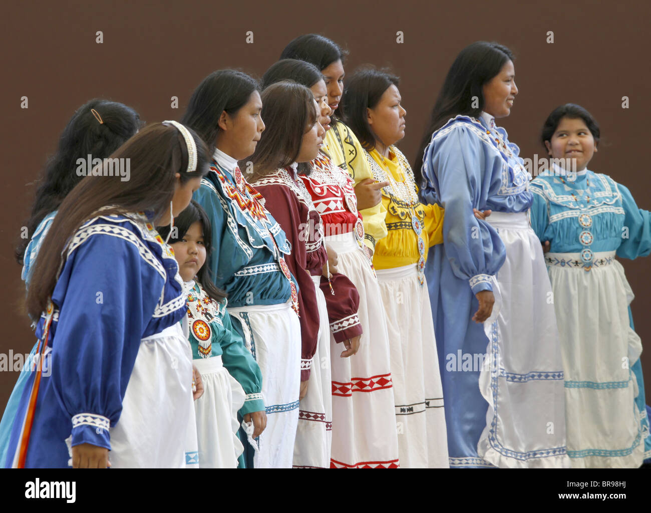Chactaw Indians women and girls performing a social dance on stage during the annual Southeast Tribes Festival. Stock Photo