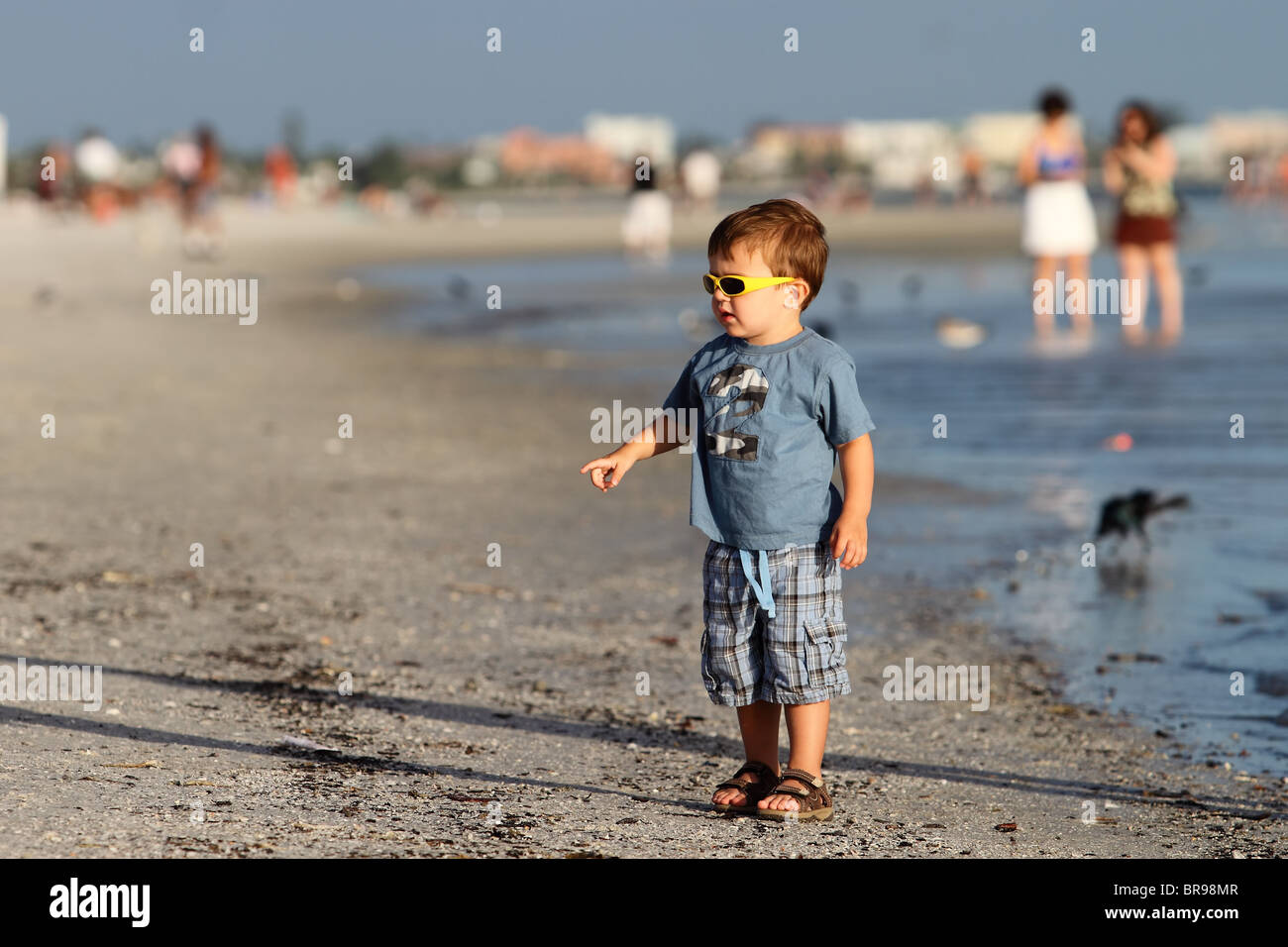 the small boy with sunglasses on the beach Stock Photo