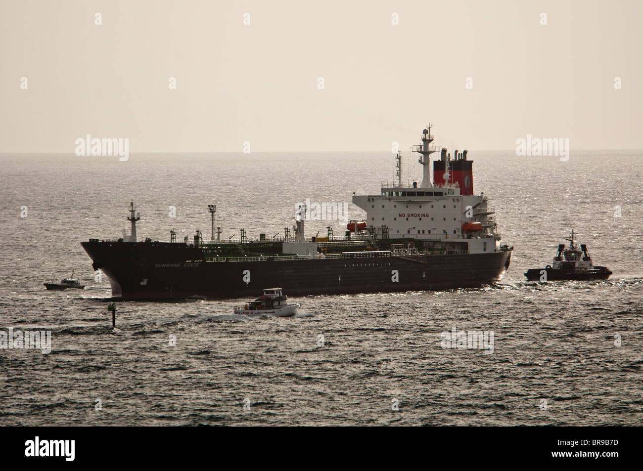 Port Everglades, Florida, USA. Oil tanker, Sunshine State docking with assistance of Seabulk Towing tug, New River. Stock Photo